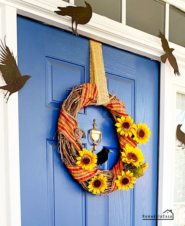 Halloween front porch with blue door and black crows