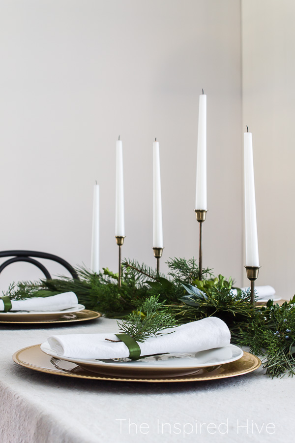 Fresh greenery holiday tablescape in a modern traditional dining room