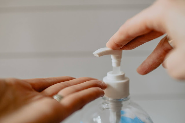 A person applying hand sanitiser