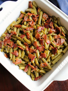 Celebrate national pork month with a plethora of pork recipes! This collection of delicious pork recipes is sure to have your mouth watering. The only question is what to make first! pan of smothered green beans dotted with bacon