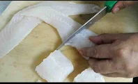 Cutting fish into cubes for fish Tikka recipe