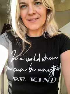 blonde woman in tshirt saying World Where You Can Be Anything Be Kind