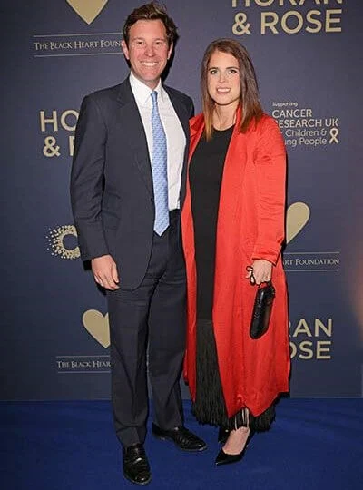 Princess Eugenie wore a black fringe-trimmed maxi dress by Sandro, and a red duster coat by Galvan,