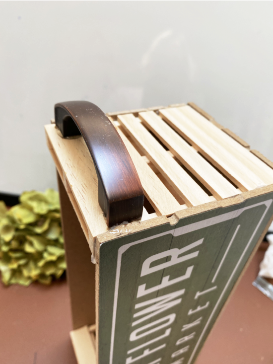 wooden crate with sign front and back and a handle