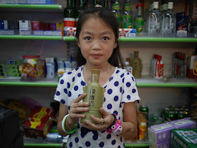 girl holding bottle of 皖酒王