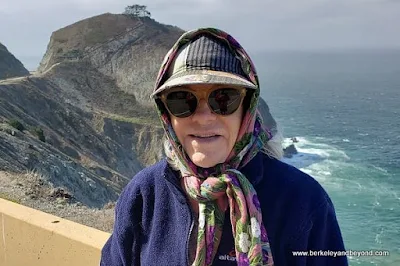 neck scarf holds on lady's hat on scenic stretch on Devil's Slide Trail in Pacifica, California