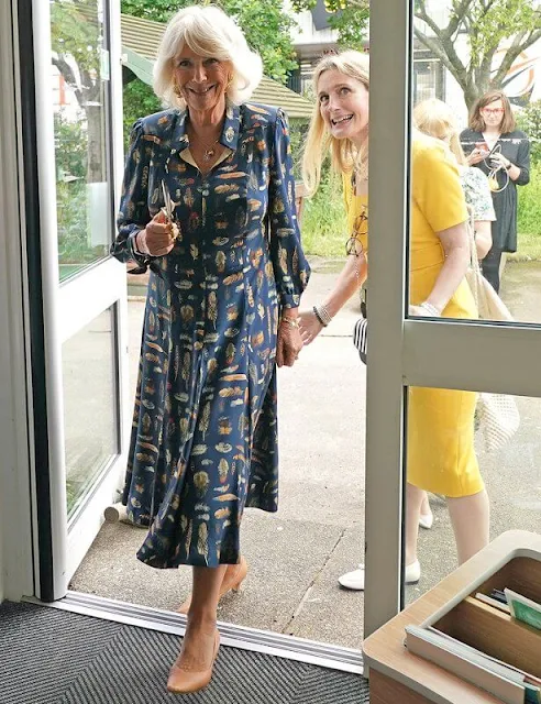 The Duchess of Cornwall wore a navy blue, feather-print dress from Fiona Clare