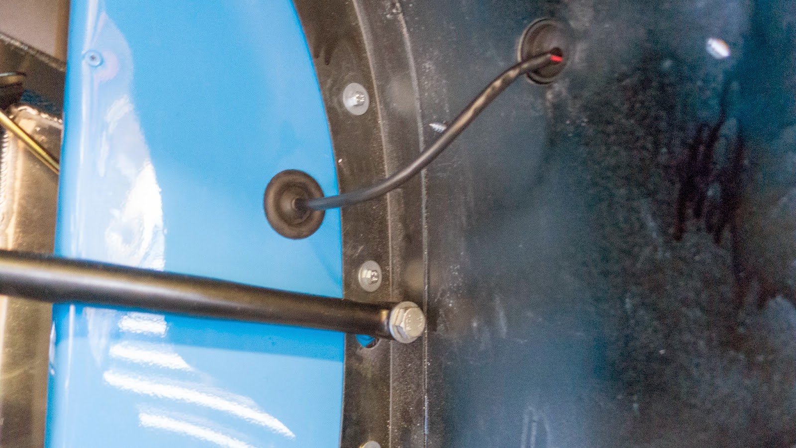 Indicator cabling routed through pre-drilled holes, plugged in behind the bodywork panel and tie wrapped in place.  The rubber grommet fits in the bodywork hole (as pictured) not the wing hole.