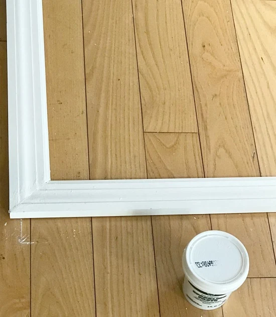 Corner of frame and joint compound on the floor