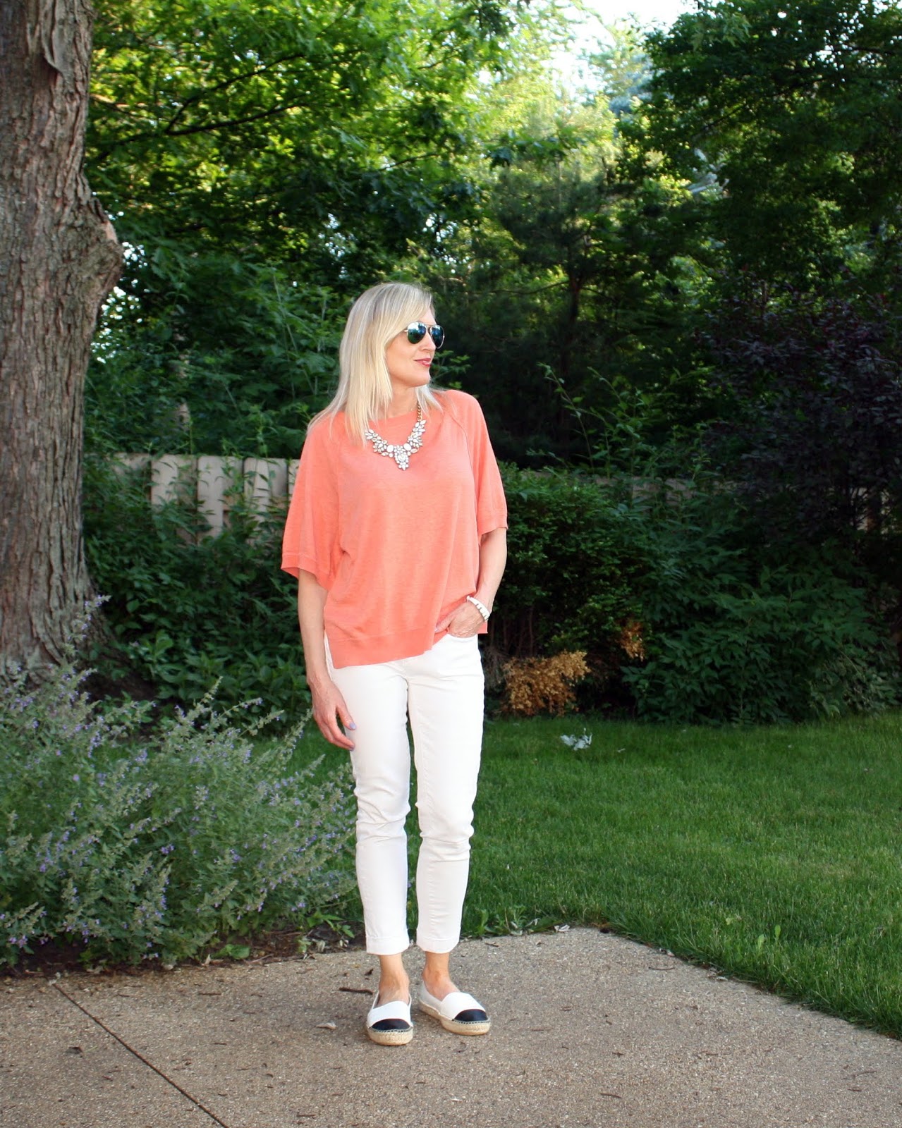 This coral top outfit is part of how to wear white jeans