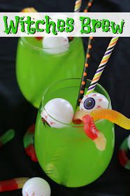 Green punch in clear glass with plastic eyeballs and gummy worms