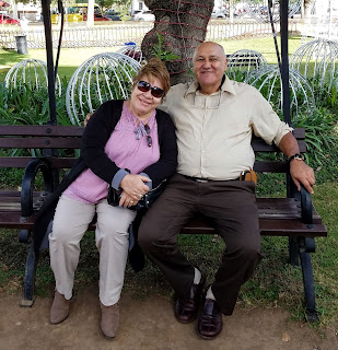 couple sitting on park bench