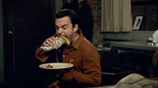 Nick Miller eating a burrito