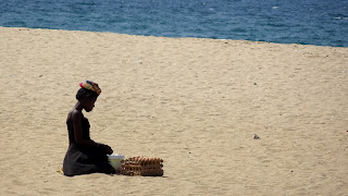 Woman sits in the beach in Luanda