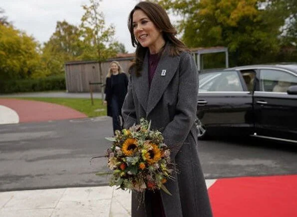 Christmas Stamp. grey long belted coat, and burgundy silk high neck long sleeve top, blouse and burgundy trousers, burgundybelted pants suit