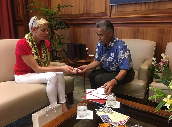 Princess Charlene of Monaco visited Honolulu, Hawaii met Governor David Idge. She wore red shirt and white pants