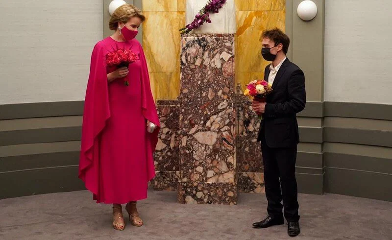Queen Mathilde wore a red fuchsia silk gown from spring summer 2020 collection of Natan. Queen Elisabeth Piano Competition 2021
