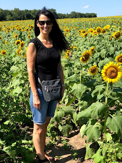 woman standing in a sunflower field