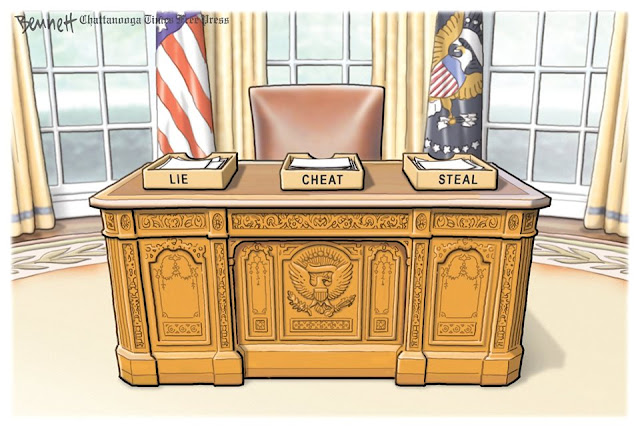 Donald Trump's desk with three in-boxes, labeled respectively, 