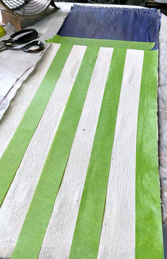 Painter's tape stripes on a canvas for red stripes