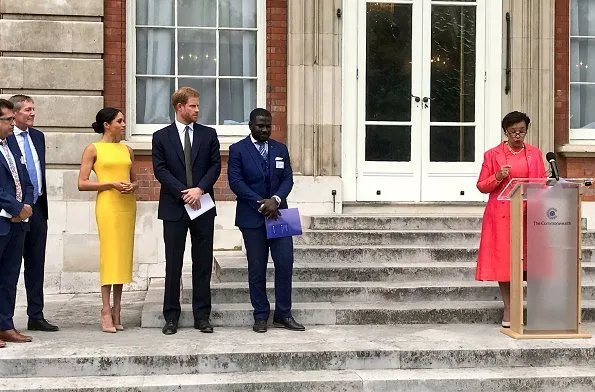 Meghan Markle wore Brandon Maxwell Yellow Crepe Midi Dress, Manolo Blahnik suede pump, Adina Reyter Diamond Amigos Curve Post Earrings