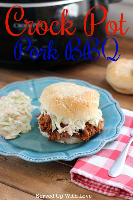 Pulled pork bbq on a bun topped with coleslaw on a blue plate with a crock pot in the back ground