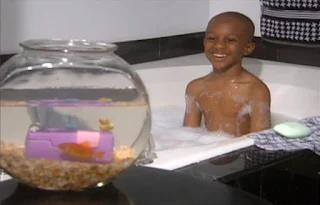 A child takes a bath in a bathtub. Sesame Street Elmo's World Bath Time Kids and Baby