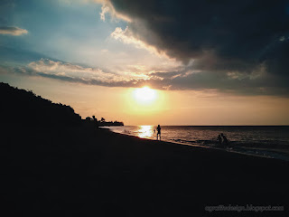 Natural Sunset Beach Panorama With People Bathing On Small Sea Waves At Umeanyar Village North Bali Indonesia