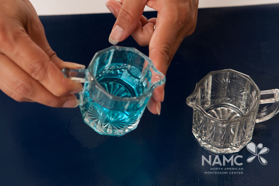 namc montessori functionality environment. adult holding pitcher