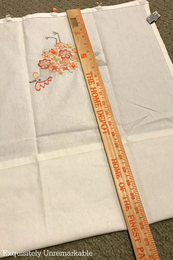 Measuring kitchen towel with yardstick