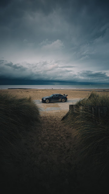 Beach, car, sand, storm, clouds, skyline