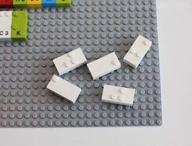 Some prototype unprinted white LEGO Braille Bricks.