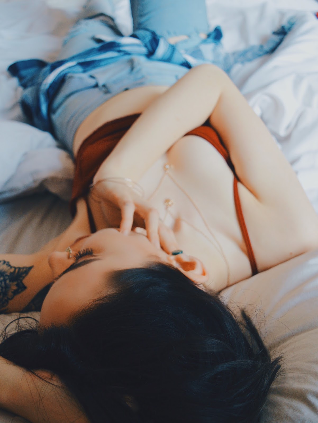 girl lying in bed fashion shot