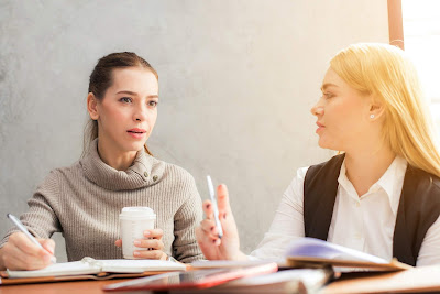 Business Women Discussing In Their Office