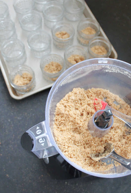 making graham cracker crusts food processor with graham cracker crumbs and some in jars to make crust