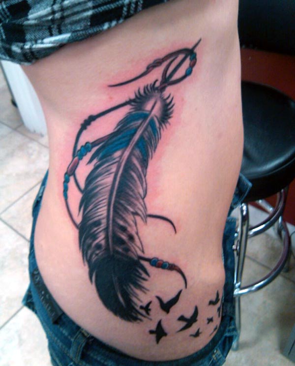 The girl side piece looks so beautiful with this amazing big feather tattoo with flying out birds