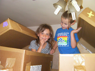 children playing in cardboard boxes