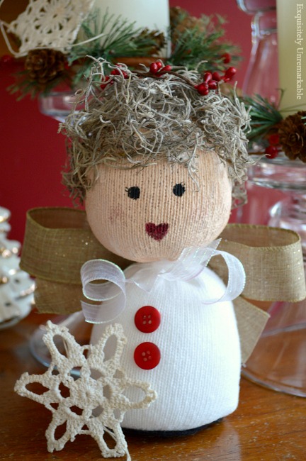 Sock angel doll on a table with a snowflake