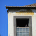 abandoned house with pigeons in the window