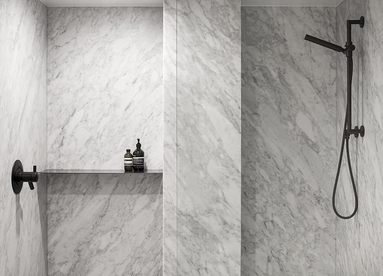 Minimalistic bathroom with marble shower by Atelier Barda