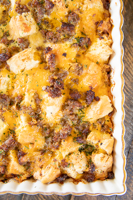 Sausage Biscuit Breakfast Casserole - only 5 ingredients! Frozen buttermilk biscuits, sausage, cheddar cheese, eggs, and milk. Can make in advance and refrigerate or freeze for later. Great for breakfast, lunch, or dinner. I took this to a potluck and it was the first thing to go! Make it ASAP! #breakfast #casserole #sausage #biscuits #freezermeal sausage breakfast casserole in baking dish