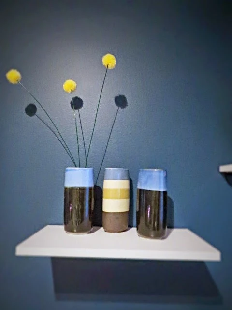 vases on shelf with faux billy ball pom poms