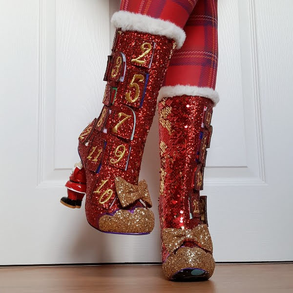 front view of red glitter and sequins boots with white fur trim and gold toe and bow