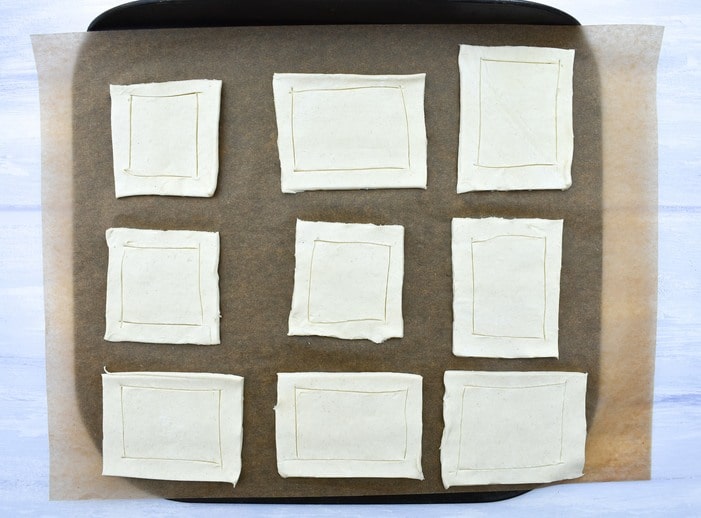 Making falafel onion pies - step 2 - pastry squares space out on tray