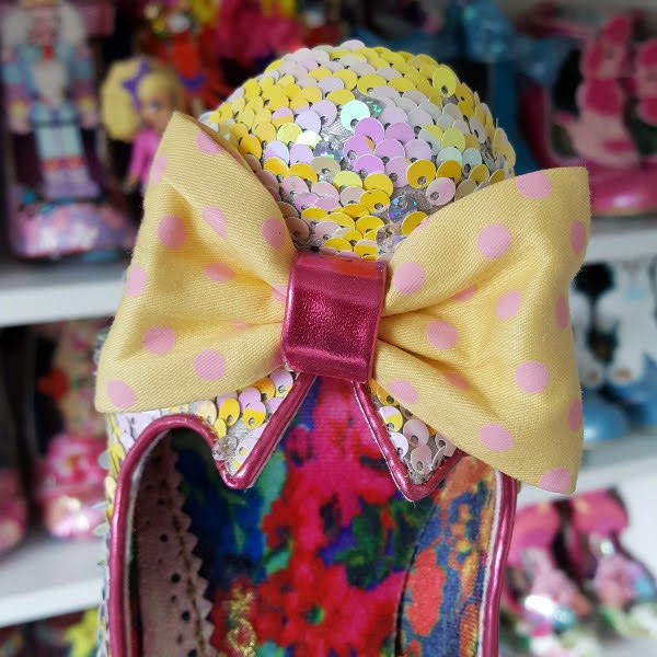 close up of pink polka dot yellow bow on front of shoe