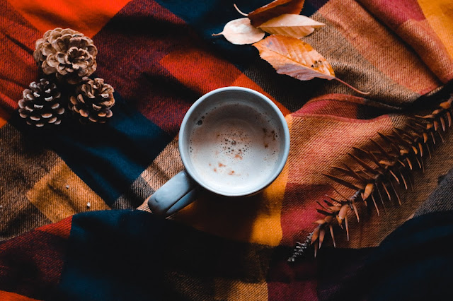 Hot chocolate drink on top of a blanket, shot flatlay-style.