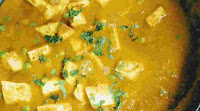 Cooking matar paneer with chopped coriander leaves