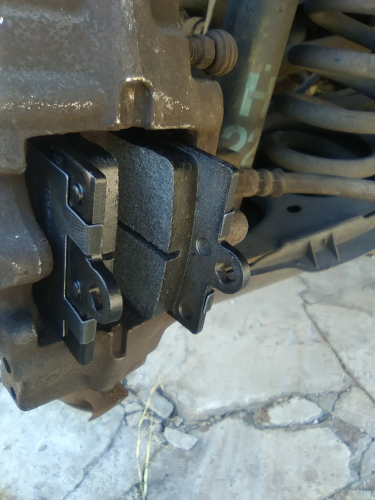 New brake pads inserted into brake caliper