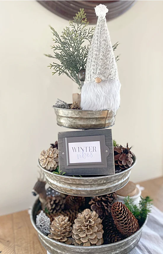 tiered tray with gnome and pinecones