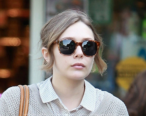 Candid photo of Elizabeth Olsen running errands while wearing a simple 